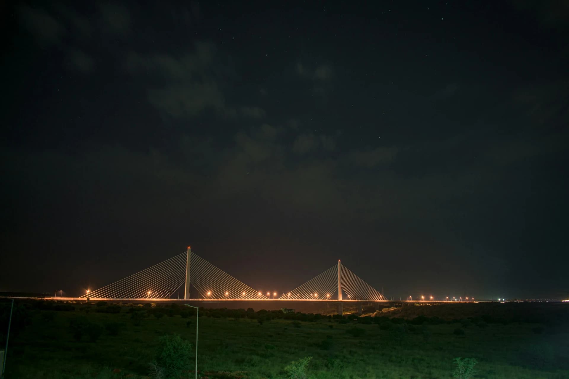Gece, aydınlatılmış bir köprü ve açık gökyüzü